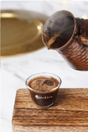 Turkish Blend poured from a copper pot into a glass cup